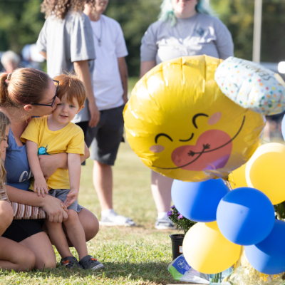 Community members pay their respects at a makeshift memorial outside of Apalachee High School in Winder, Georgia. 