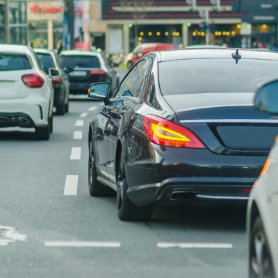 A busy street with cars changing lanes