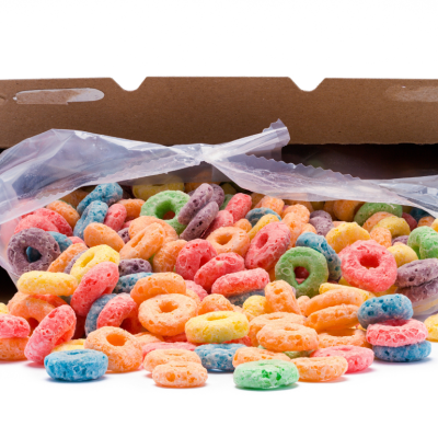 A spilled box of Froot Loops cereal against a white background