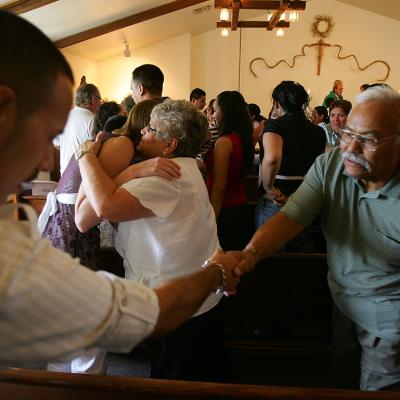 Parishioners greet each other during the English/Spanish bilingual mass at Mission San Rafael Catholic near Huntington, Utah.