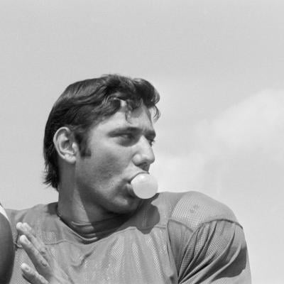 NFL quarterback Joe Namath chews bubble gum during passing practice at the Jets' training camp at Hofstra University in 1968.