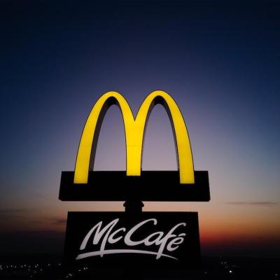 Glowing McDonalds restaurant sign against night sky