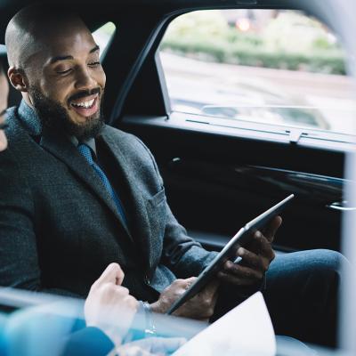 Two business professionals in a car ride going to a business meeting.