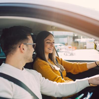 A man shows interior of car to prospective buyer.