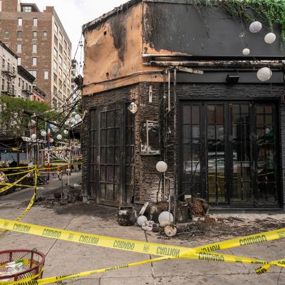 The remains of the outdoor dining and facade of a restaurant after a fire in Chelsea, New York.