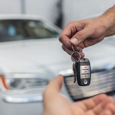 A man returns car keys at a dealership.