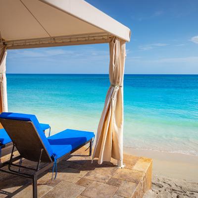 Two chairs set on the pier and gazebo overlooking an idyllic Caribbean beach in Montego Bay, Jamaica.