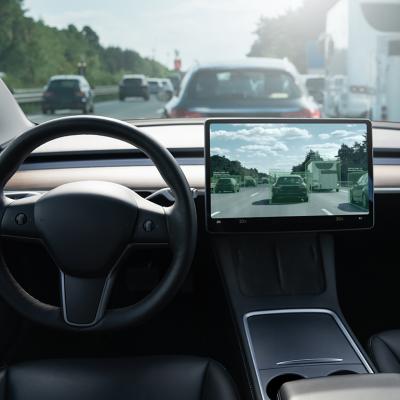 An autonomous car on the road with a display showing how it detects nearby cars and their movements.