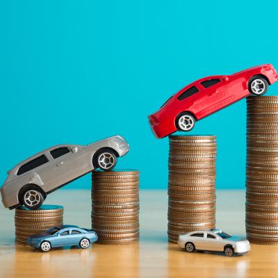 Car figures rising on top of coins.