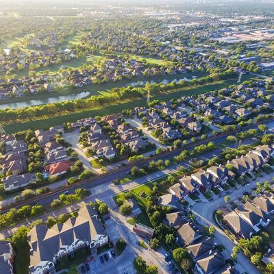 An aerial view of suburban residential houses neighborhood during sunset in Houston, Texas.