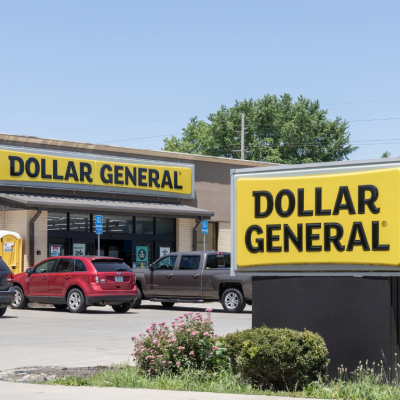 The exterior of a Dollar General store with cars parked outside