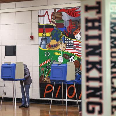 A voter cast their ballot in the Michigan primary election at Dearborn High School.