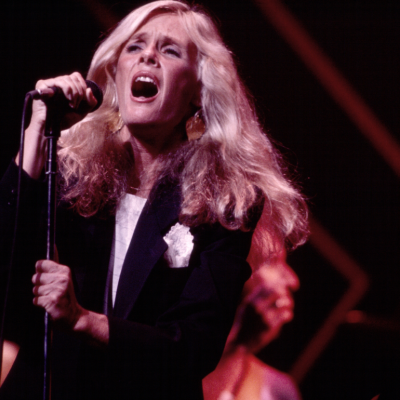 American singer Kim Carnes performs, with her band, onstage at the Savoy, New York, New York, August 25, 1981. 