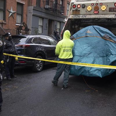 Police enforce a sweep of a homeless encampment, throwing tents and other possessions of the homeless in a trash truck in the East Village neighborhood of New York City.