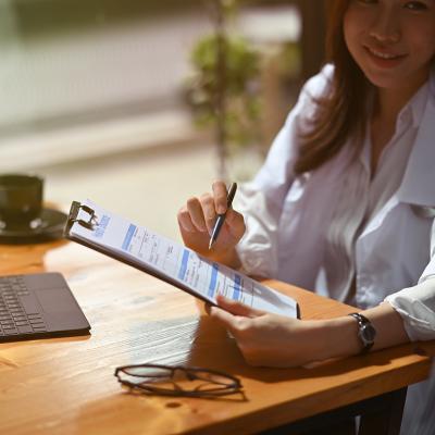 Female healthcare professional guiding patient in filling up insurance forms.