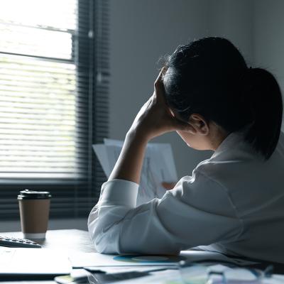 Female employee feeling stressed at work.