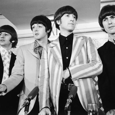 The Beatles—from left, Ringo Starr, Paul McCartney, John Lennon, and George Harrison—standing in front of four microphones in New York 1966.