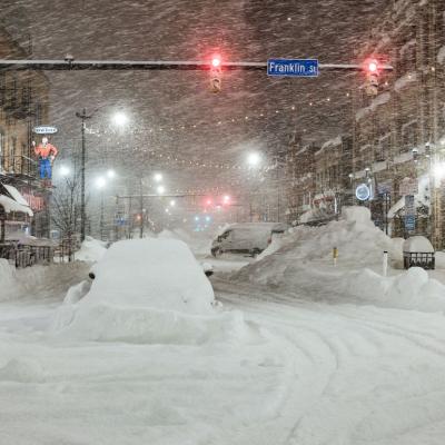 Vehicles are seen abandoned in heavy snowfall in downtown Buffalo, New York, on Dec. 26, 2022.