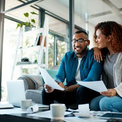 Couple happily discussing finances.