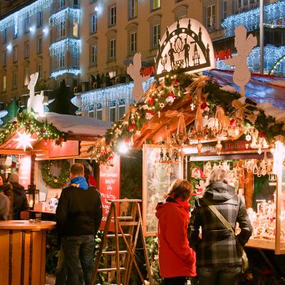 People shopping around stalls during holiday season in Dresden, Germany where there is the older Christmas market.