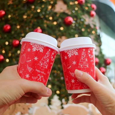 Holiday coffee cups are cheered in front of a Christmas tree.