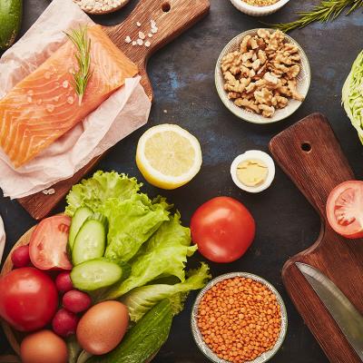 Salmon, walnuts, fruits and vegetables rich in phytoestrogens and fatty acids laid on a table for meal prep.