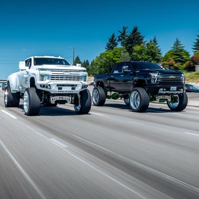 Two lifted trucks on the road in Seattle, WA.