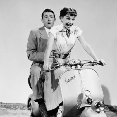 Gregory Peck and Audrey Hepburn riding a Vespa in the 1953 comedic romance 'Roman Holiday'