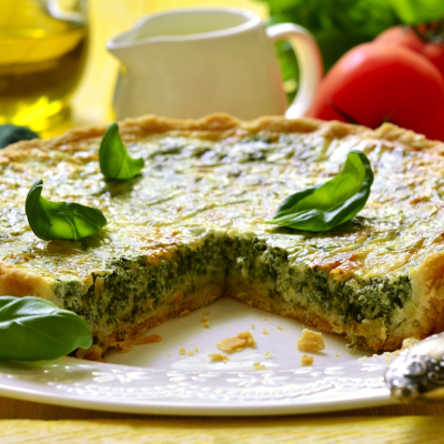 Spinach quiche with a slice cut out