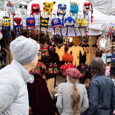 People shopping for Christmas related gifts in an annual downtown market in Washington, DC during the holidays.