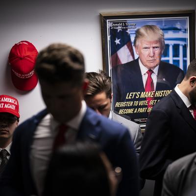 Staff gathering around in a Trump campaign headquarters.