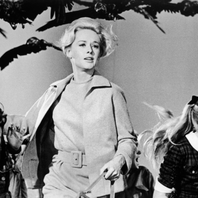 American actor Tippi Hedren and a group of children run away from the attacking crows in a still from the film 'The Birds' directed by Alfred Hitchcock. 