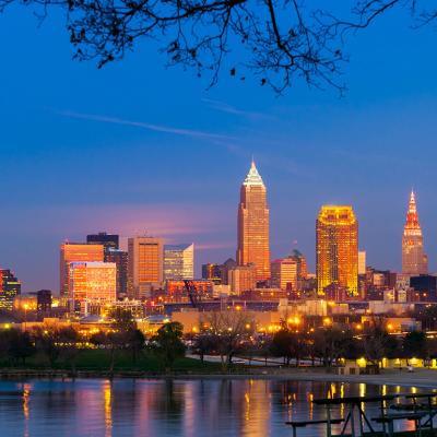 City downtown view of Cleveland, Ohio as it lights up during sunset.