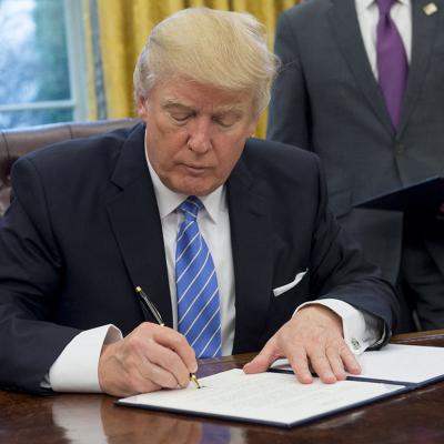 Donald Trump signing an executive order withdrawing the US from the Trans-Pacific Partnership in the Oval Office of the White House in Washington, DC back in January 23, 2017.