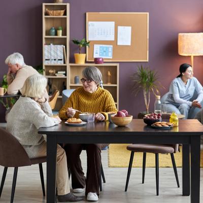 A group of seniors engaging in recreational activities in an assisted living facility.