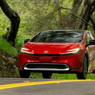 A red 2025 Toyota Prius on the road.