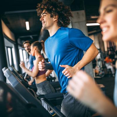 People running on treadmills at a health club.