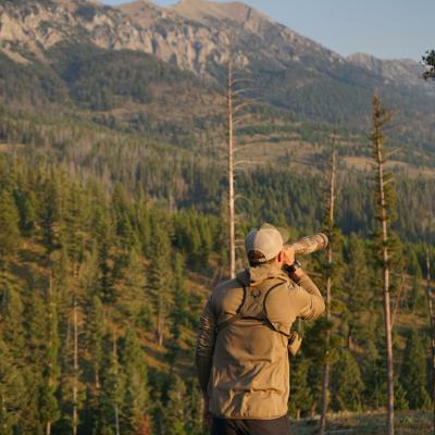 Man looking over a mountainous area and sightseeing. 