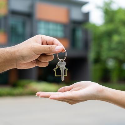 A woman being handed the keys to her first home.