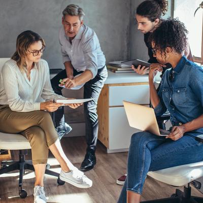 A diverse group of entrepreneurs engaged in a project plan discussion.