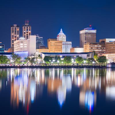 A view of Peoria, Illinois' downtown skyline and lake at dusk.