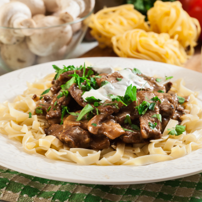 Homemade beef stroganoff with mushrooms and tagliatelle pasta