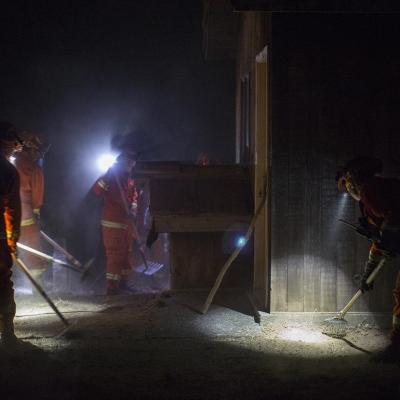 The Puerta la Cruz female inmate firefighter crew clears vegetation near homes in Dry Creek Canyon to try to save them as the Partrick Fire approaches west of Napa, Calif.