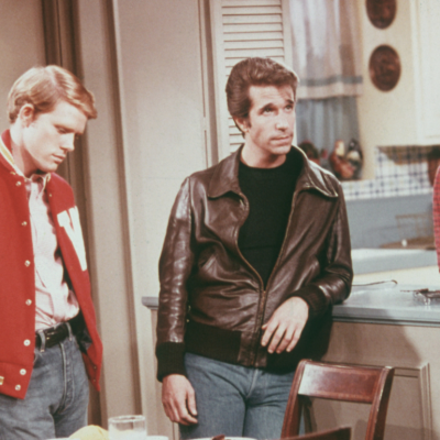 American actors Henry Winkler, as Arthur 'Fonzie' Fonzarelli, Ron Howard as Richie Cunningham, and Marion Ross as Marion Cunningham, in a scene from the television sitcom 'Happy Days', circa 1975.