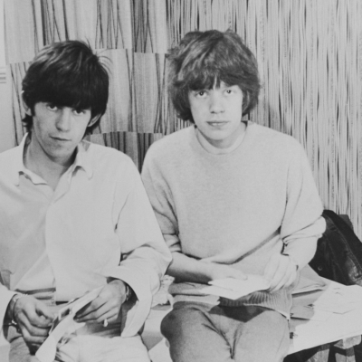 Rolling Stones singer Mick Jagger and guitarist Keith Richards opening fan mail during the early days of the band, circa 1963. 