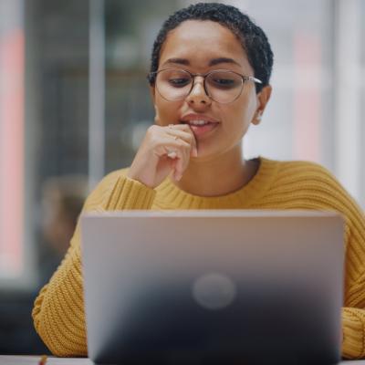 Person reading over email on their laptop.