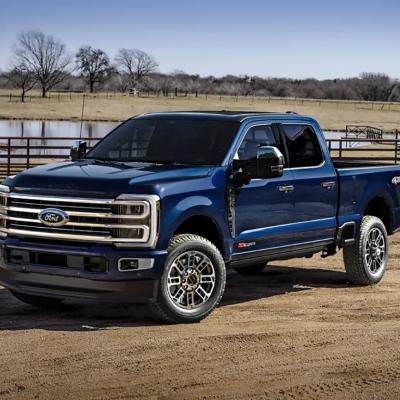 A blue 2025 Ford F-350 Super Duty displayed on a ranch.