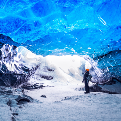 A person standing in an ice cave in the Skaftafell area of Vatnajokull National Park, Iceland