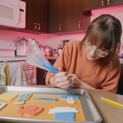 Kitchen Founder Emily Henegar icing custom cookies.