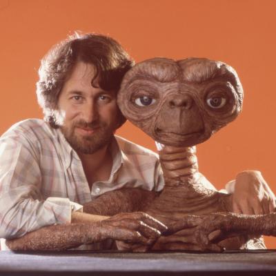 Director Steven Spielberg poses with E.T. in April 1982 in Los Angeles, California.